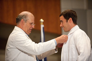At the 2010 White Coat Ceremony, Dean Jerry Strauss helped incoming students into their first white coats.