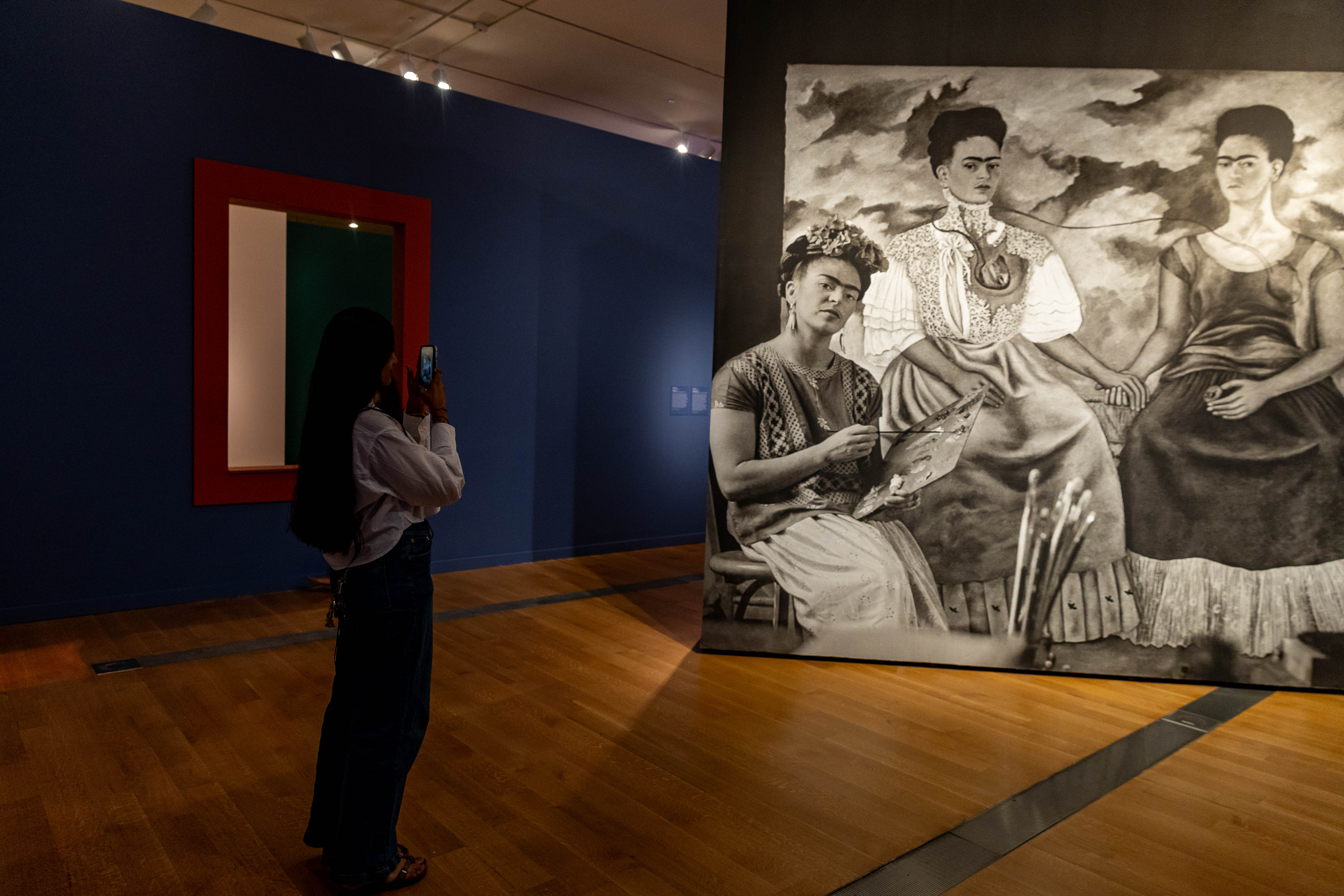 Neha Shah from the Class of 2027 takes a photo of the art.