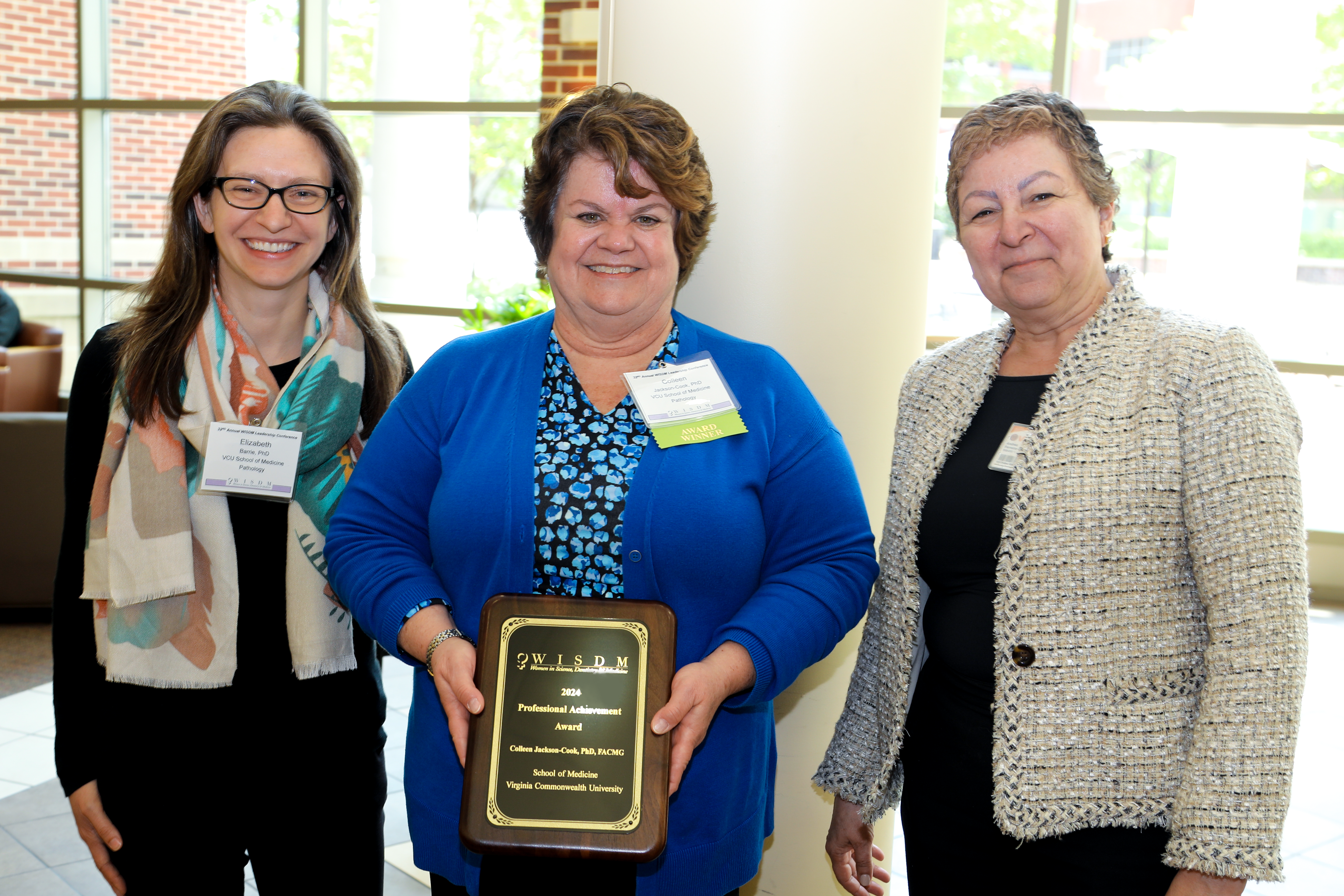 Colleen Jackson-Cook, Ph.D. (center) attended the 2024 WISDM awards ceremony with Department of Pathology colleagues Elizabeth Barrie, Ph.D. (left) and Andrea Ferreira-Gonzalez, Ph.D. (right). 