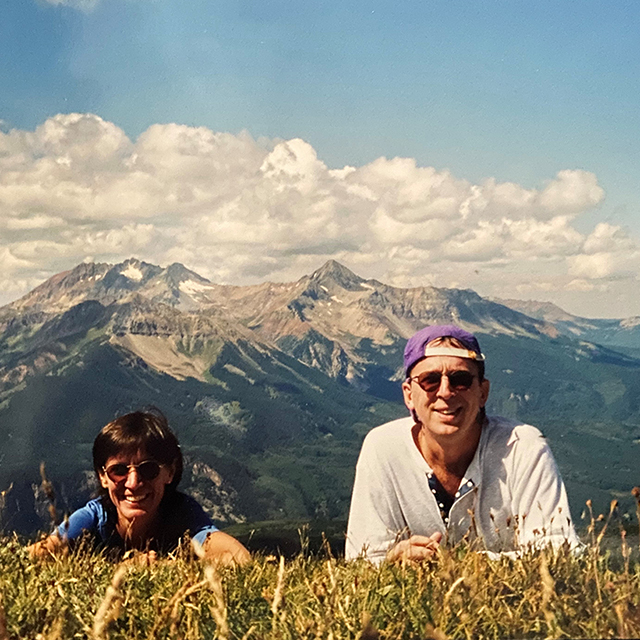 photo of man and woman on the top of a mountain