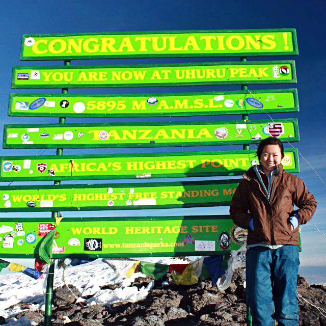 woman at the top of Mt. Kilimanjaro