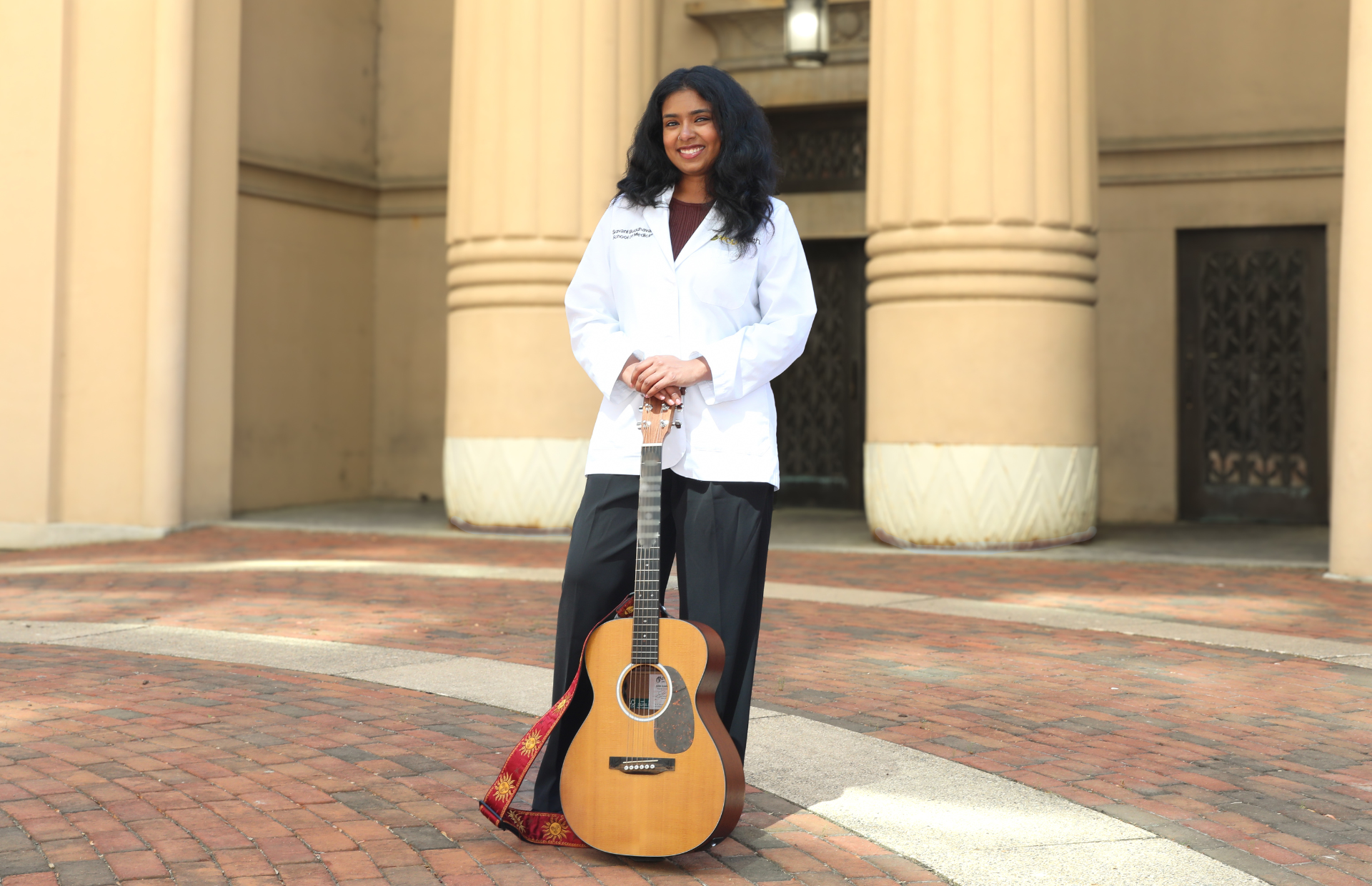Matched M4 Sravani Buddhavarapu with her guitar, which she taught herself to play as an undergraduate (Photo by Arda Athman, School of Medicine)