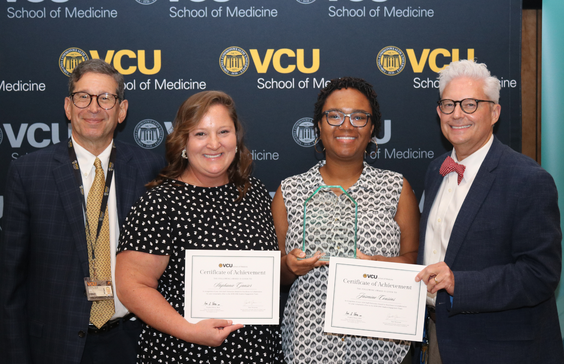 (From left) School of Medicine interim dean Stephen Kates, M.D., Excellence in Collaboration Award recipients Stephanie Ganser and Jasmine Cousins, and chief administrative officer and senior associate dean for business affairs Paul Peterson at the 2026 Staff Distinction Awards (Photo by Arda Athman, School of Medicine)