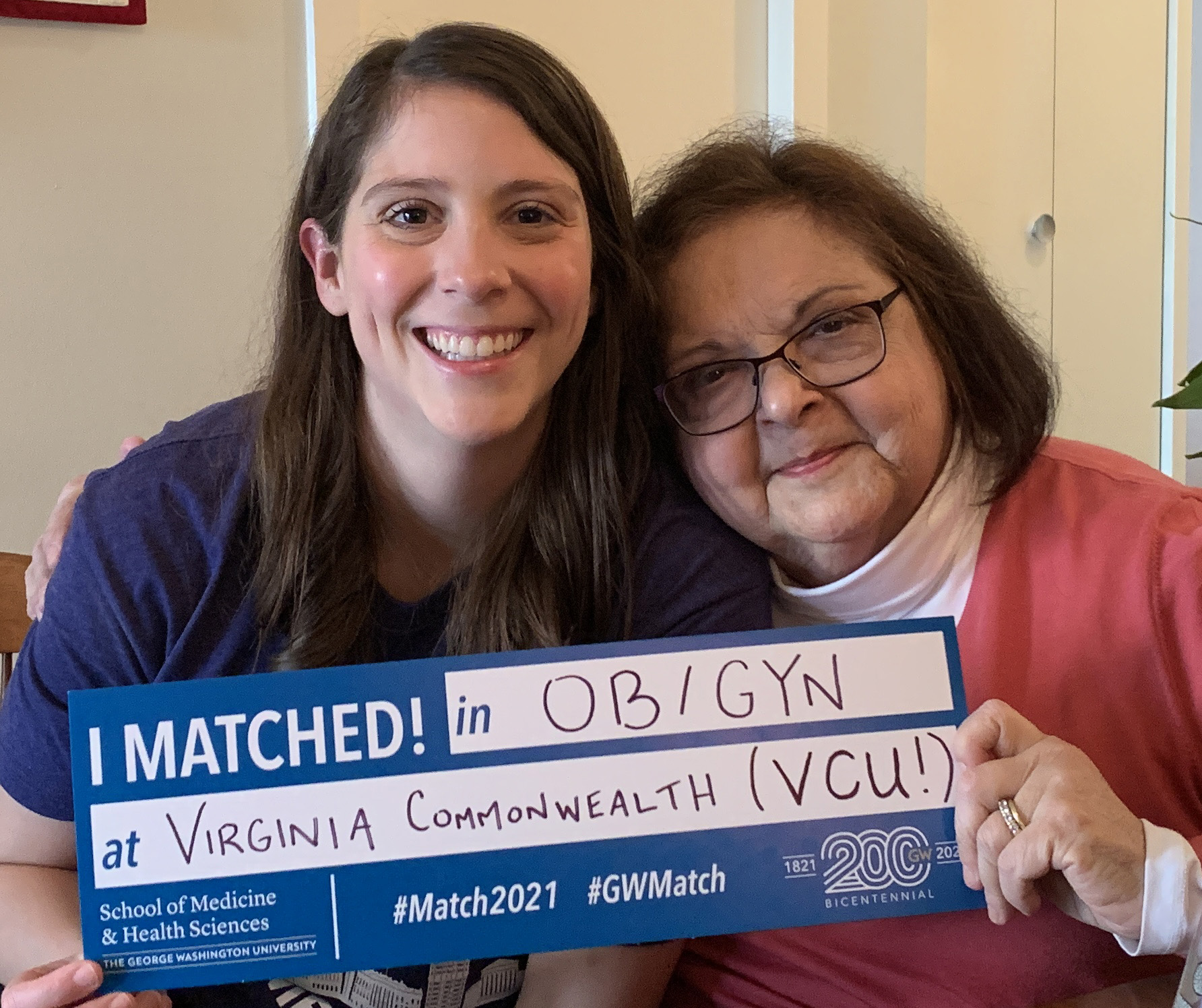 Two women hold Match Day sign with text I matched in OB-GYN at Virginia Commonwealth University!