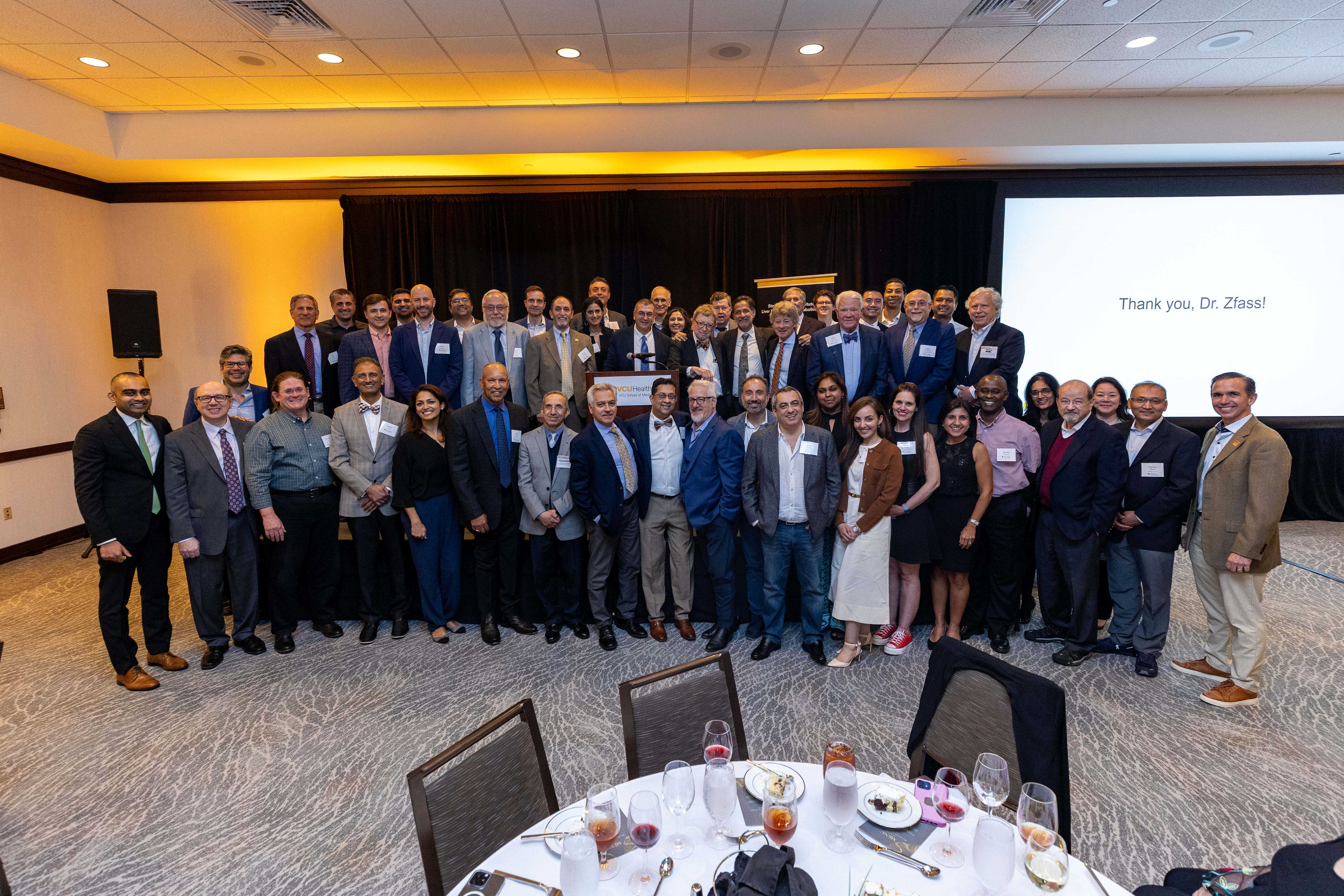 Faculty, alumni and trainees gather to celebrate the career of Alvin M. Zfass, M.D., following the 29th annual Virginia Liver Symposium and Update in Gastroenterology. (Photo by Skip Rowland)