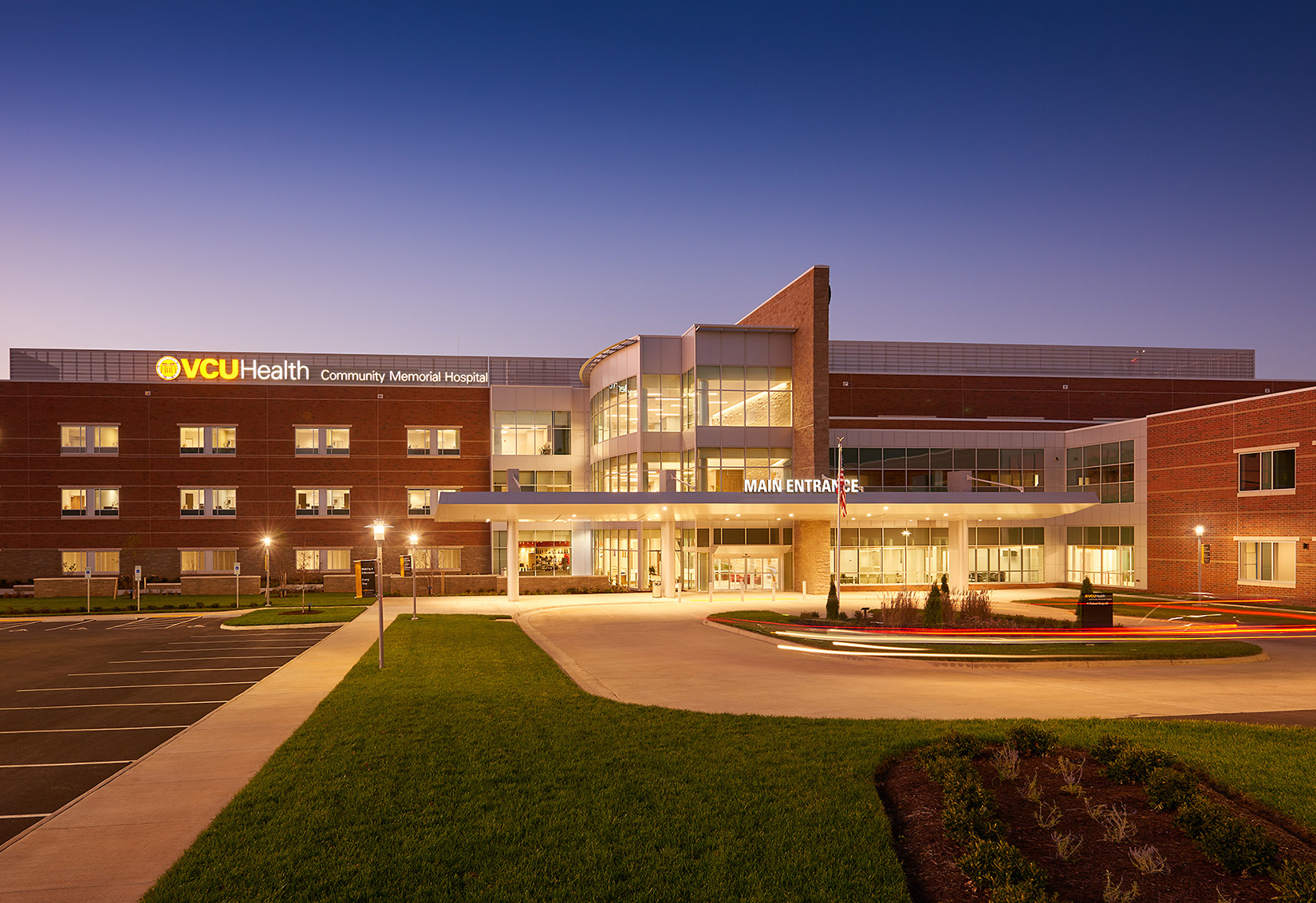 View of VCU Health Community Memorial Hospital's main entrance at dusk