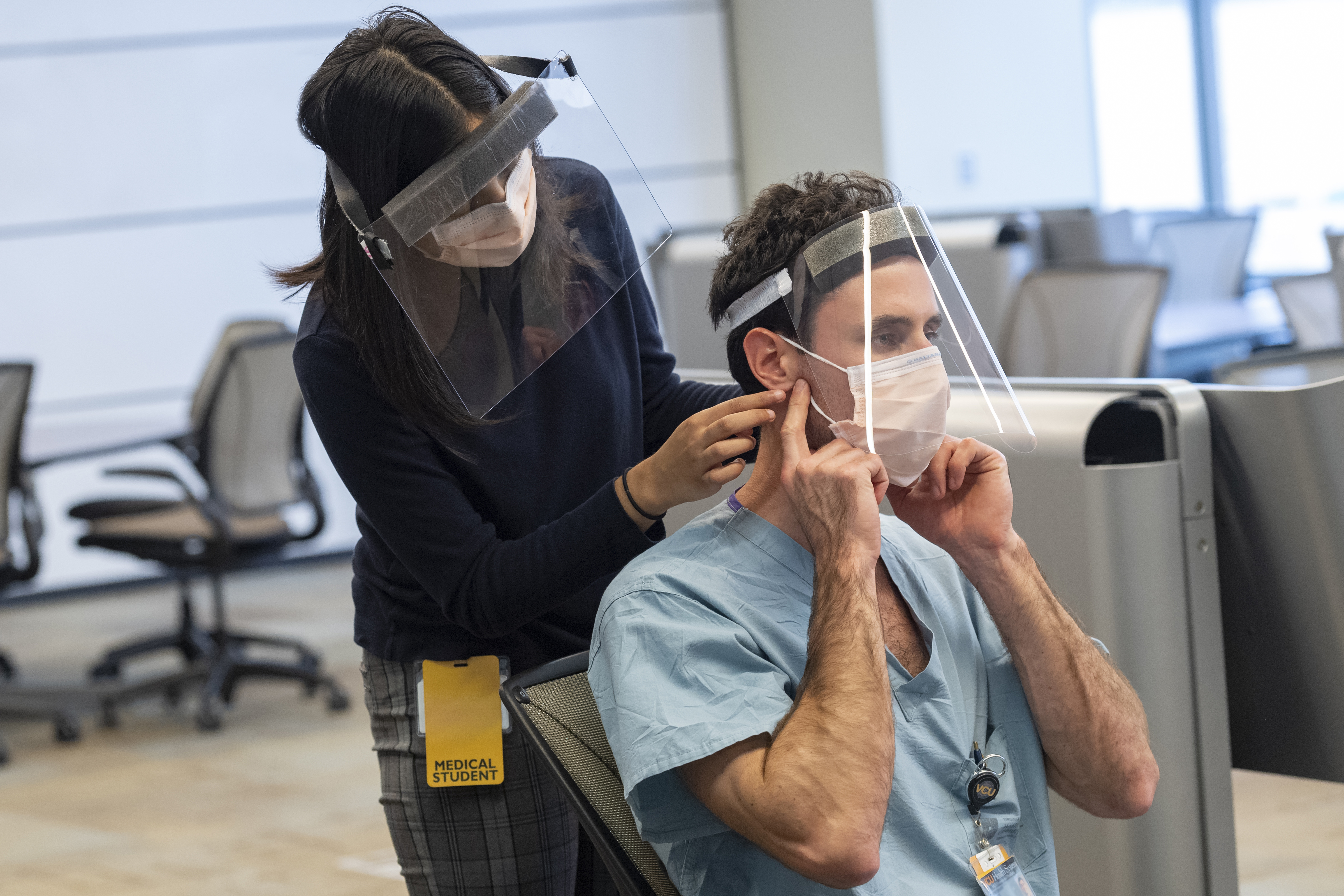 Two first-year students in the Practice of Clinical Medicine course practice physical exam skills.