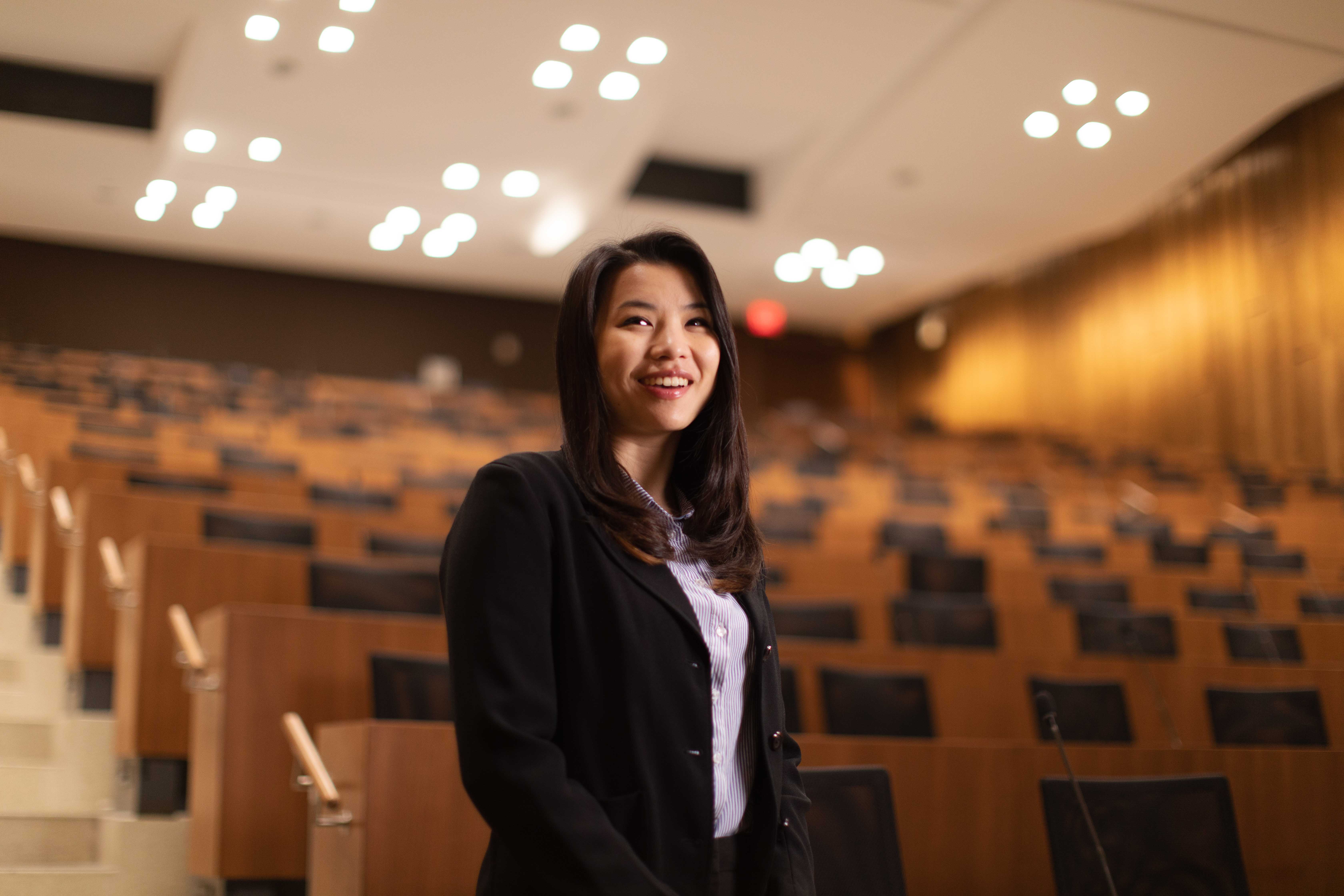 Nicole Ng standing in a lecture hall