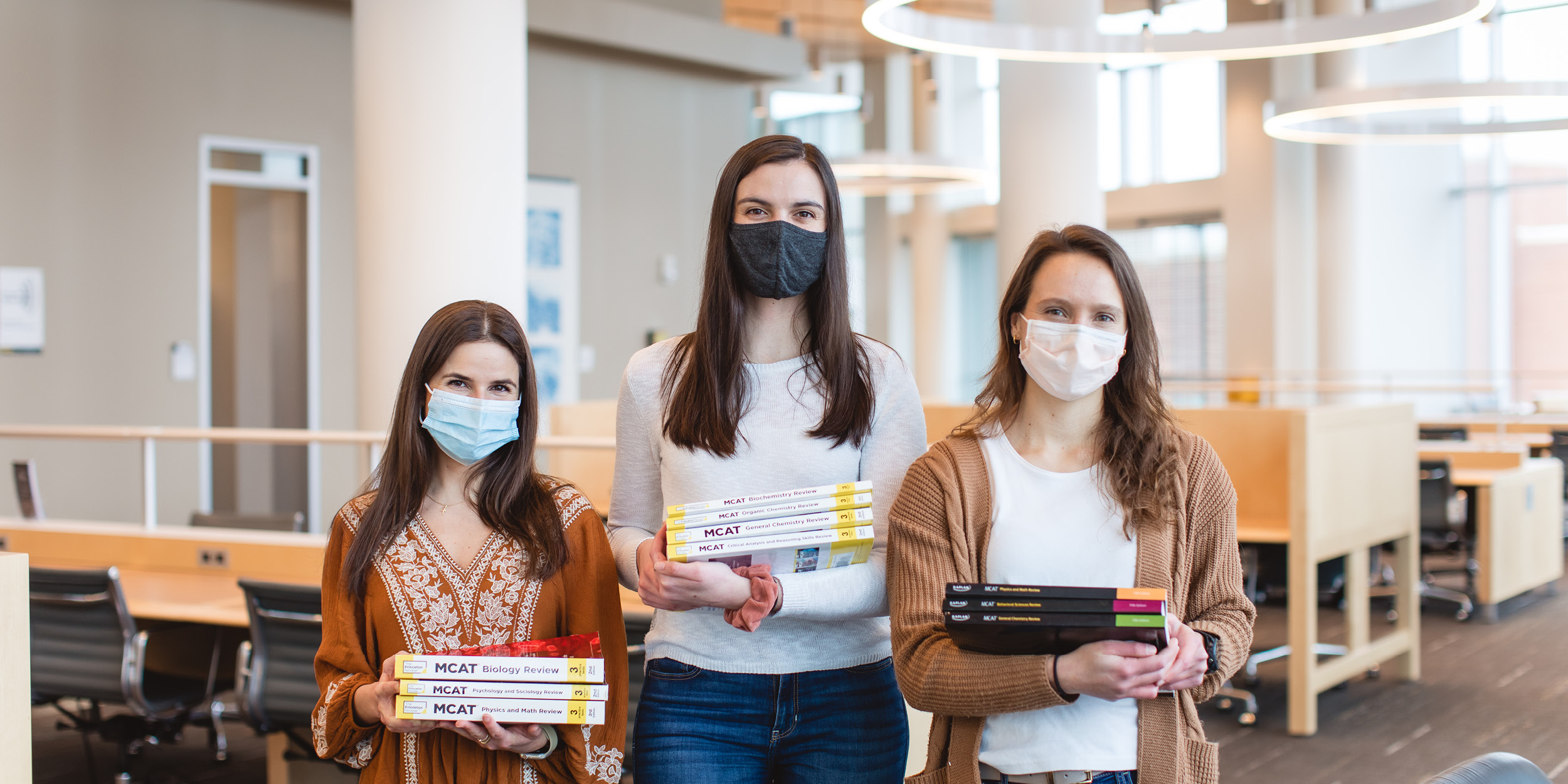 Students holding MCAT books