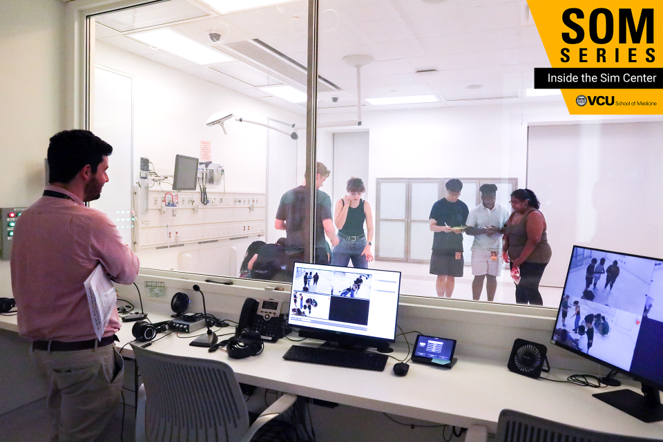 Ricardo Bello, M.D., an assistant professor in the Department of Surgery, observes first-year medical students during their introduction to the Sim Center (Photo by Arda Athman, School of Medicine)