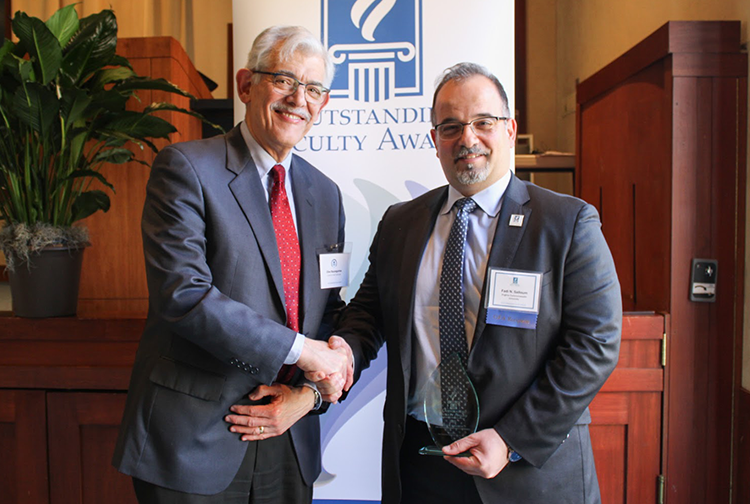 Clive M. Baumgarten, Ph.D., shakes hands with Dr. Salloum