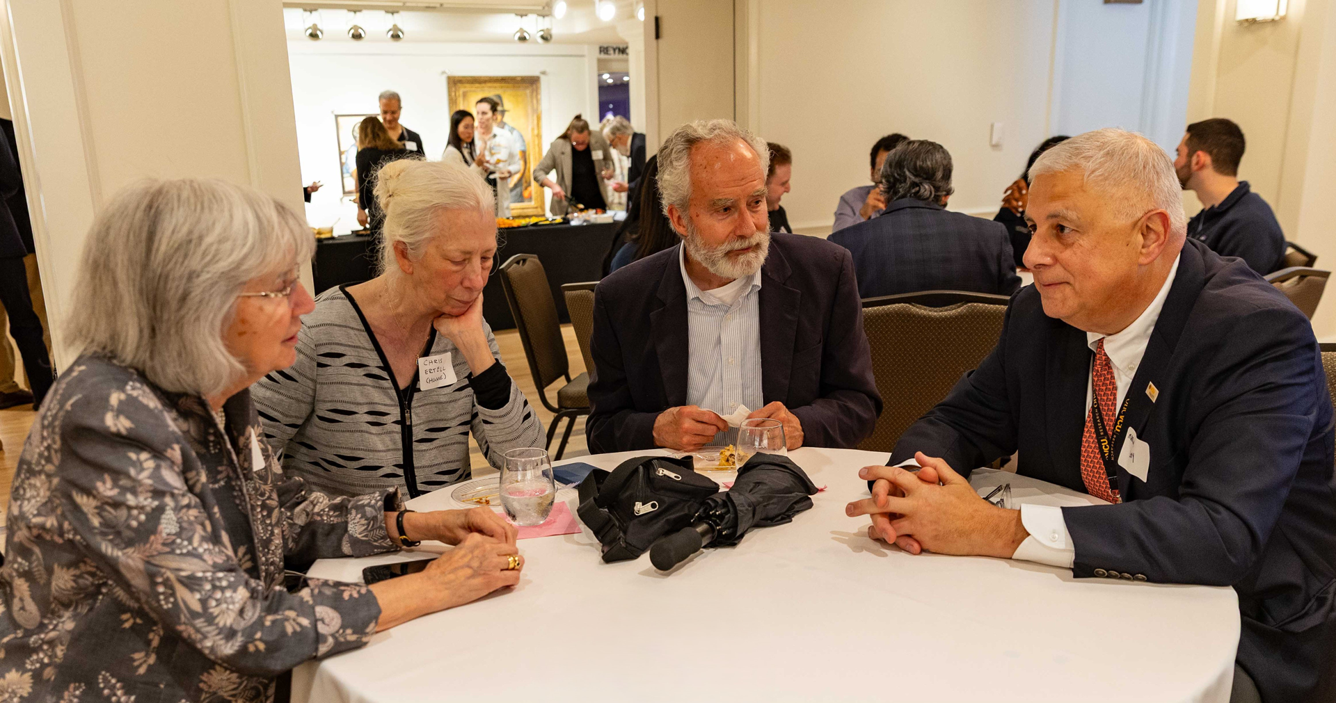 Dr Levy sits with a family