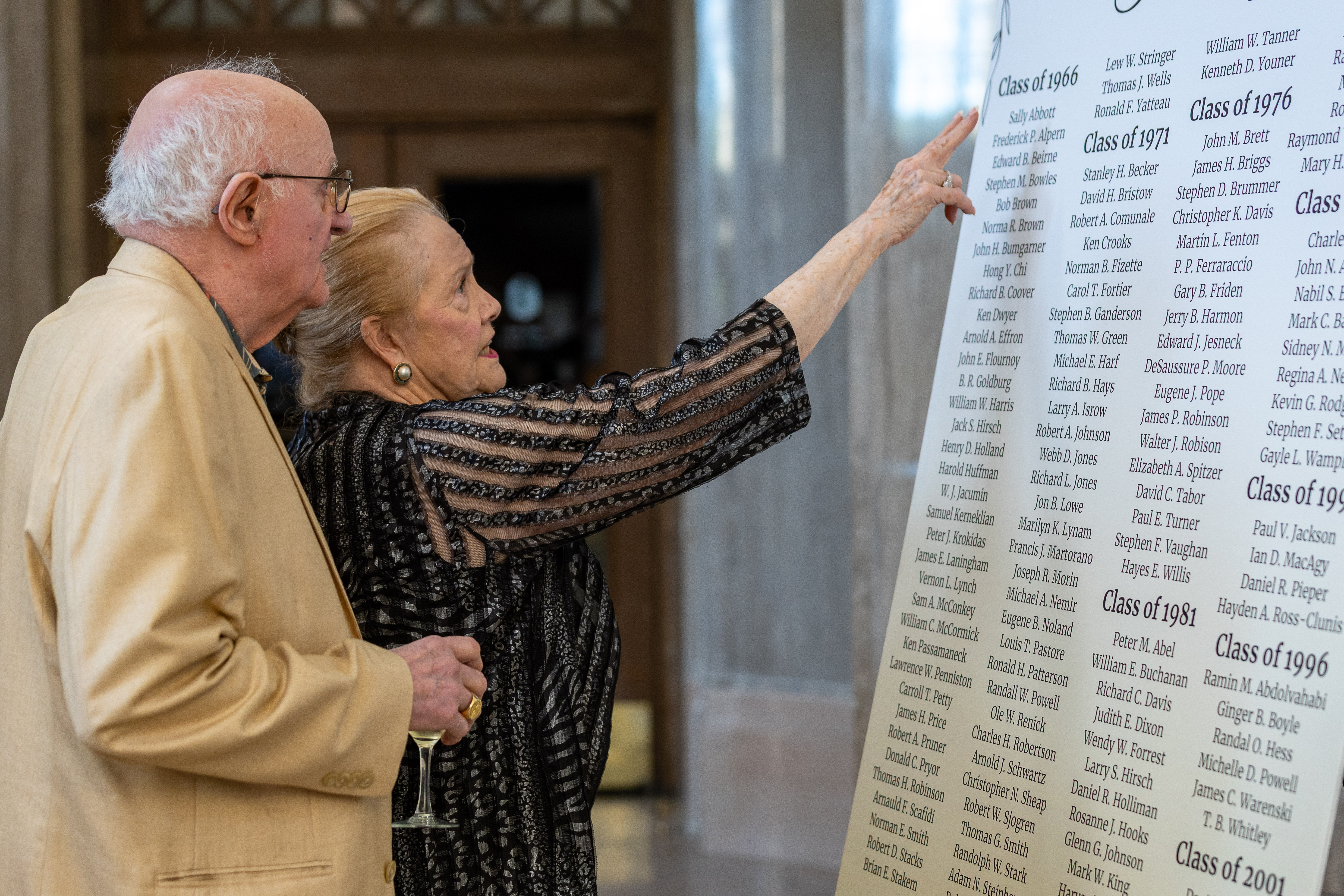  Alumni look at class list. 