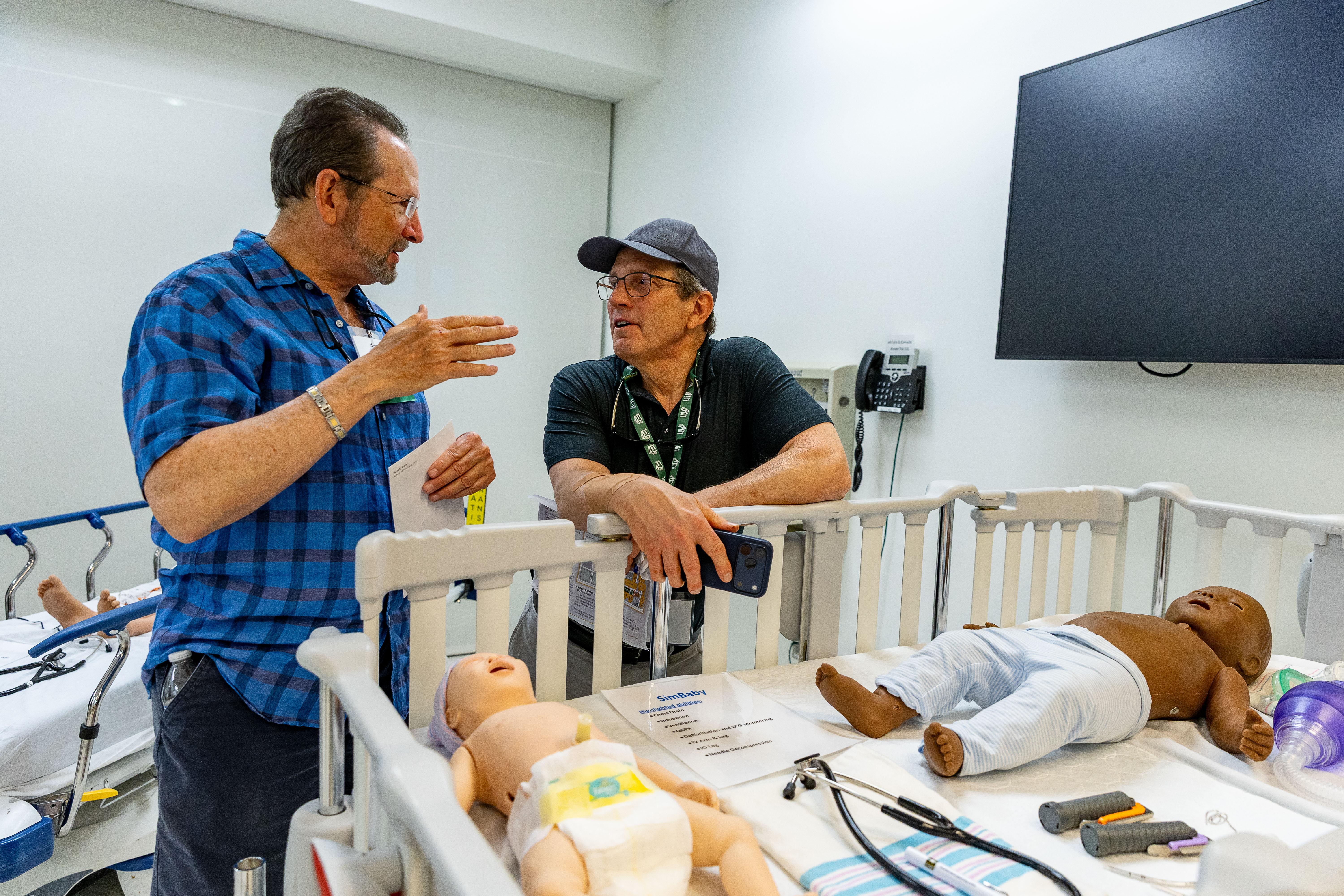  Alumni discuss premature baby simulation. 