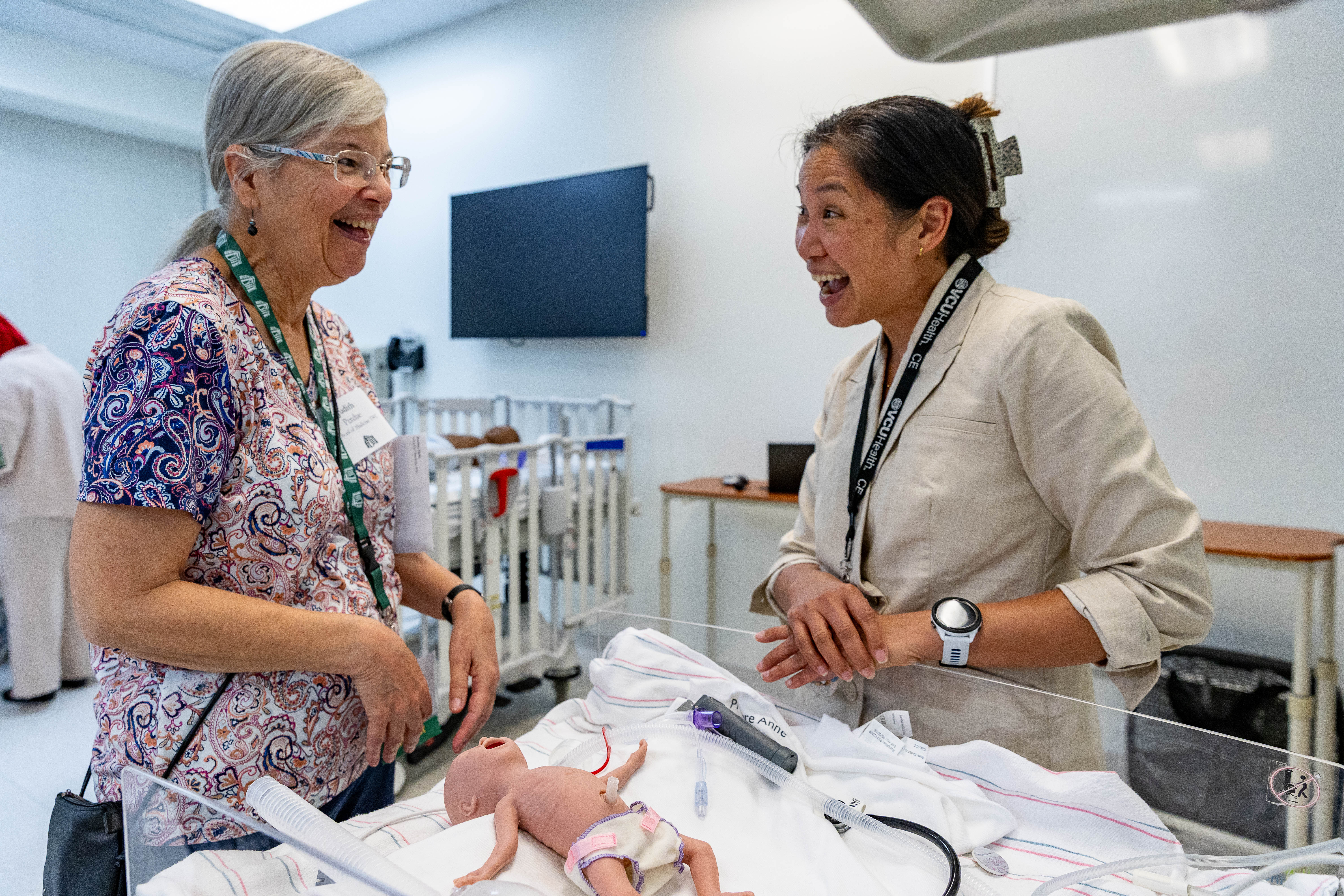  Alumna talks with physician during simulation. 