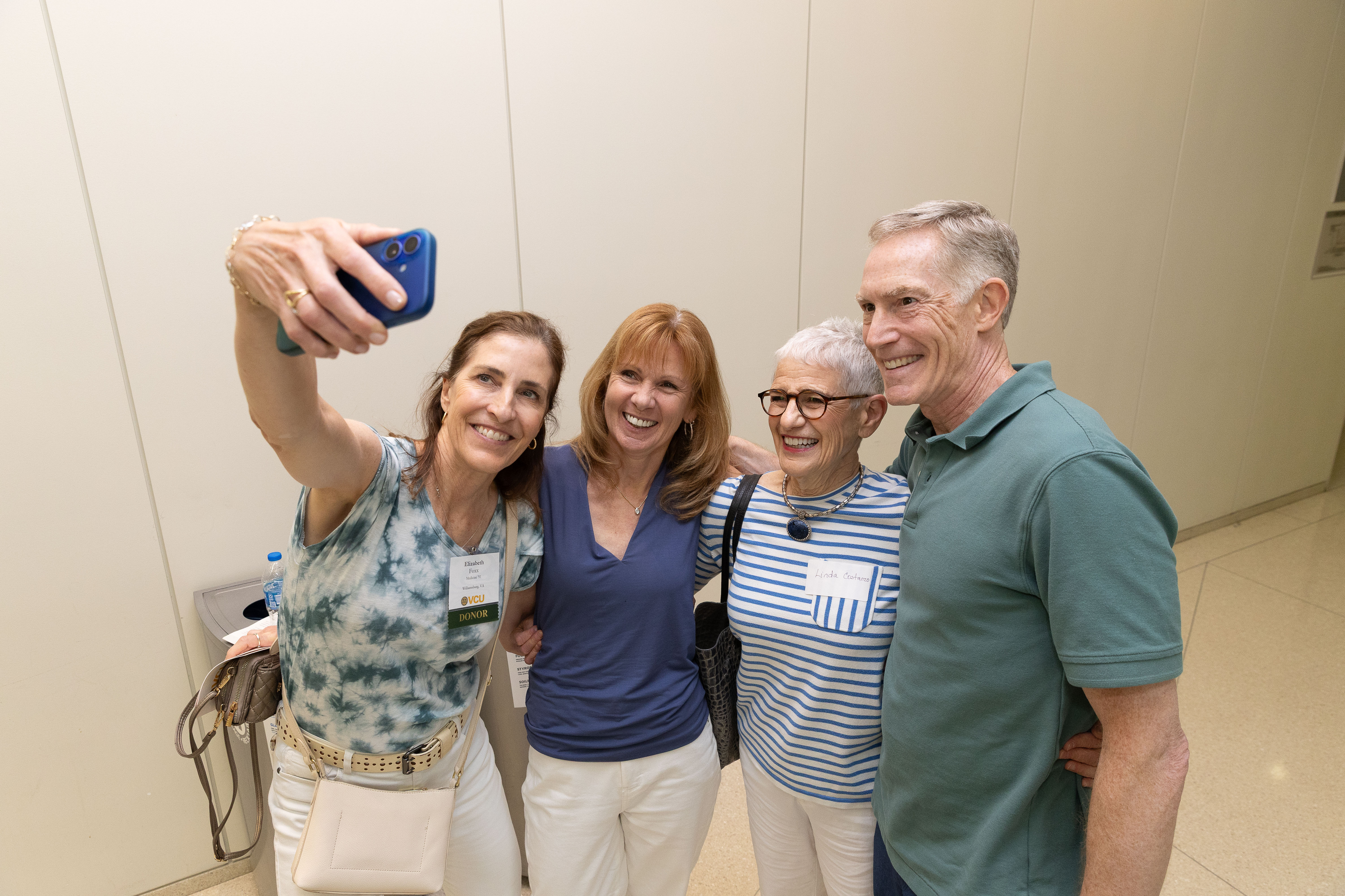  Alumni pose for a selfie with retired faculty member Linda Costanzo, Ph.D. 
