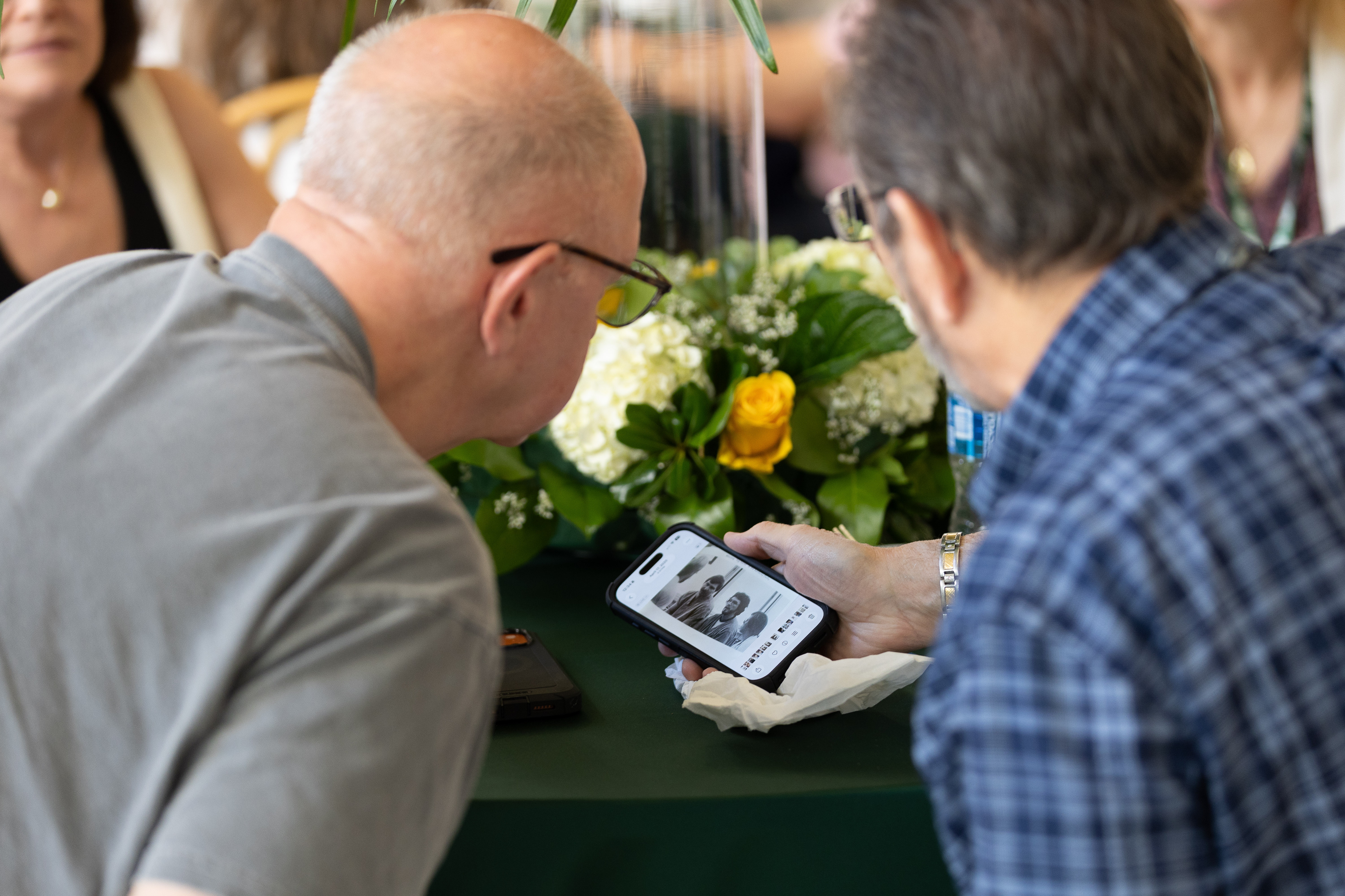  Alumnus shares a photo from his medical school days on his phone. 