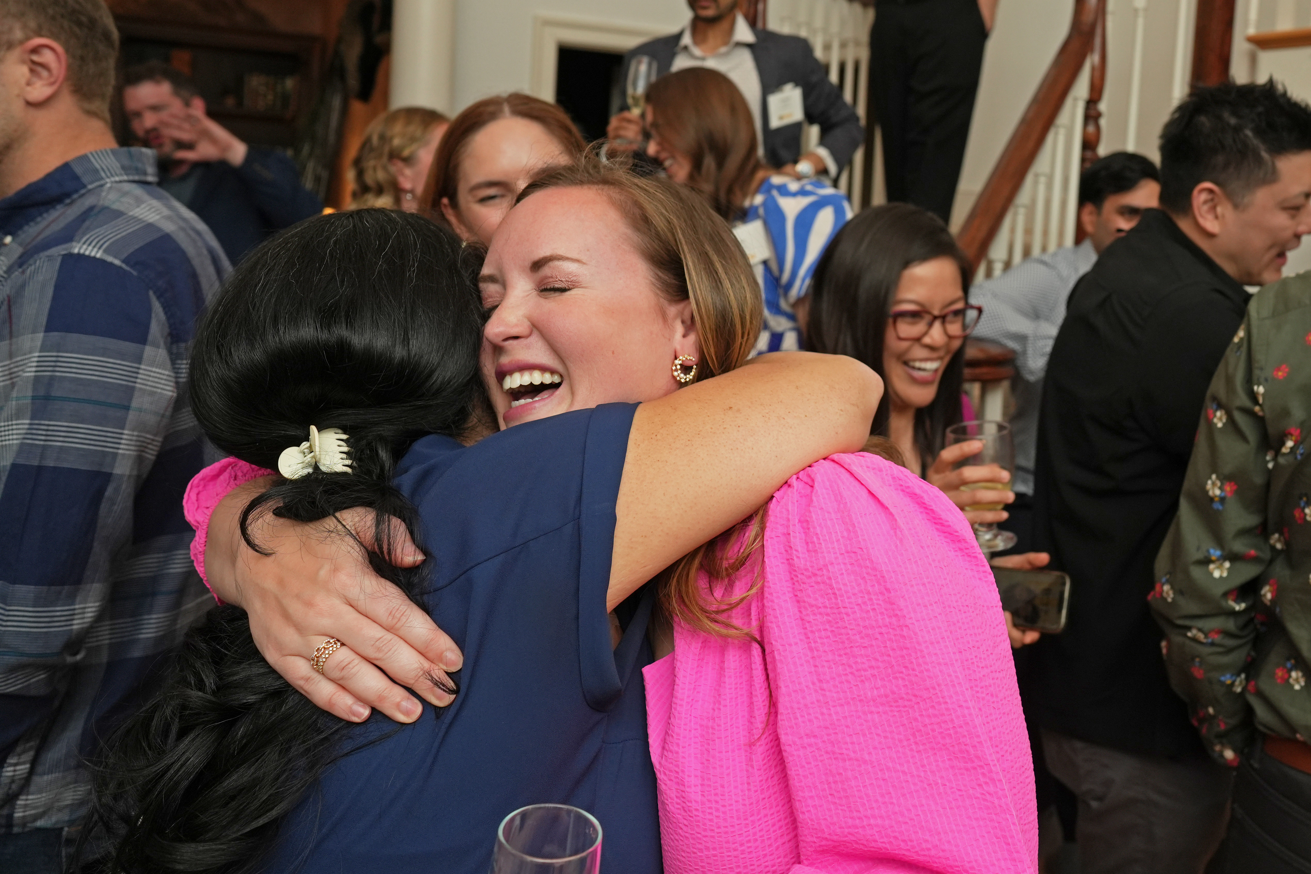 Stephanie Lee, M’15, Class of 2015 reunion chairperson, reunites with classmates at their class party hosted by Samarth Gola, M’15, H’20. Photo by Skip Rowland.