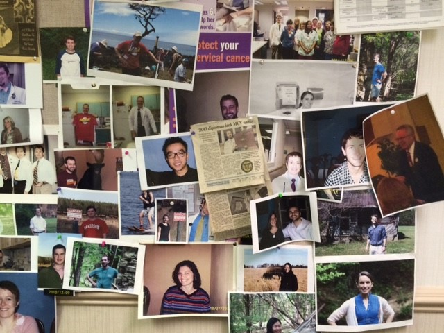 A bulletin board of past students and their newspaper clippings hangs in the office of Randall Suslick, M'73