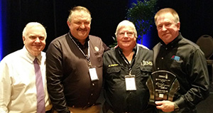 Ed Racht, H’87 (right), and Rob Lawrence (second from left), chief operating officer of Richmond Ambulance Authority, with event organizers.