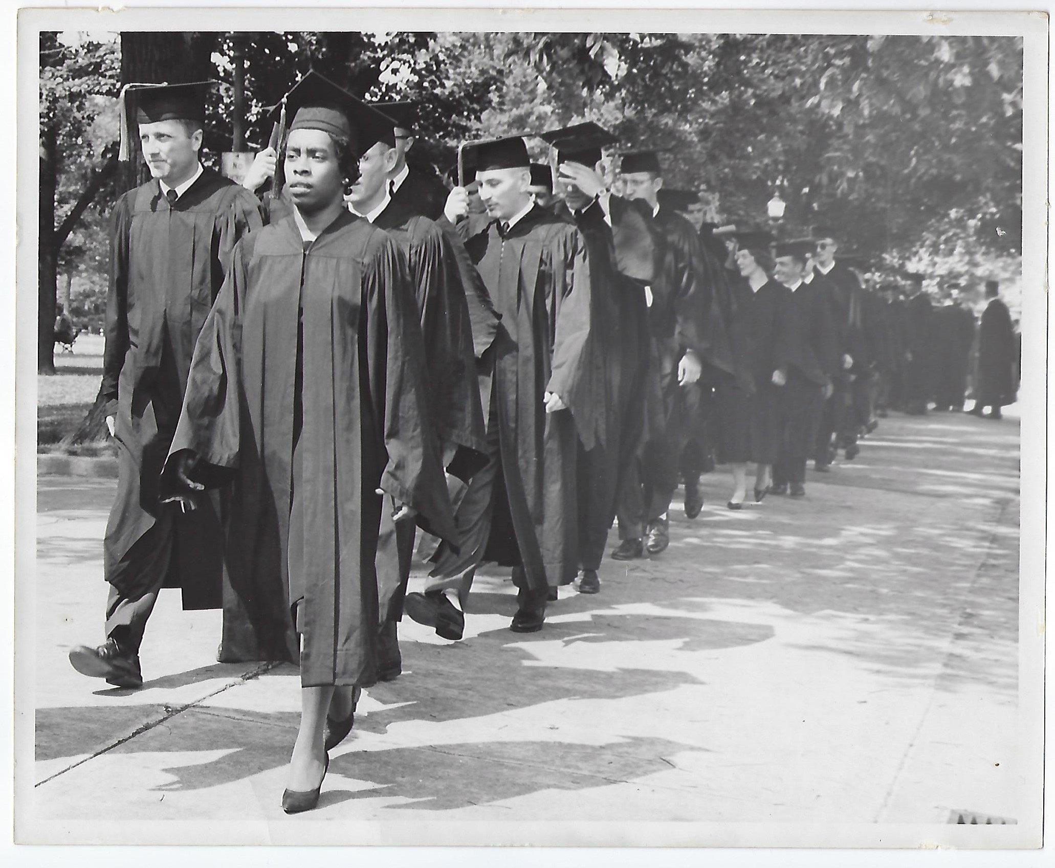 Norma Goodwin leading other graduates down sidewalk