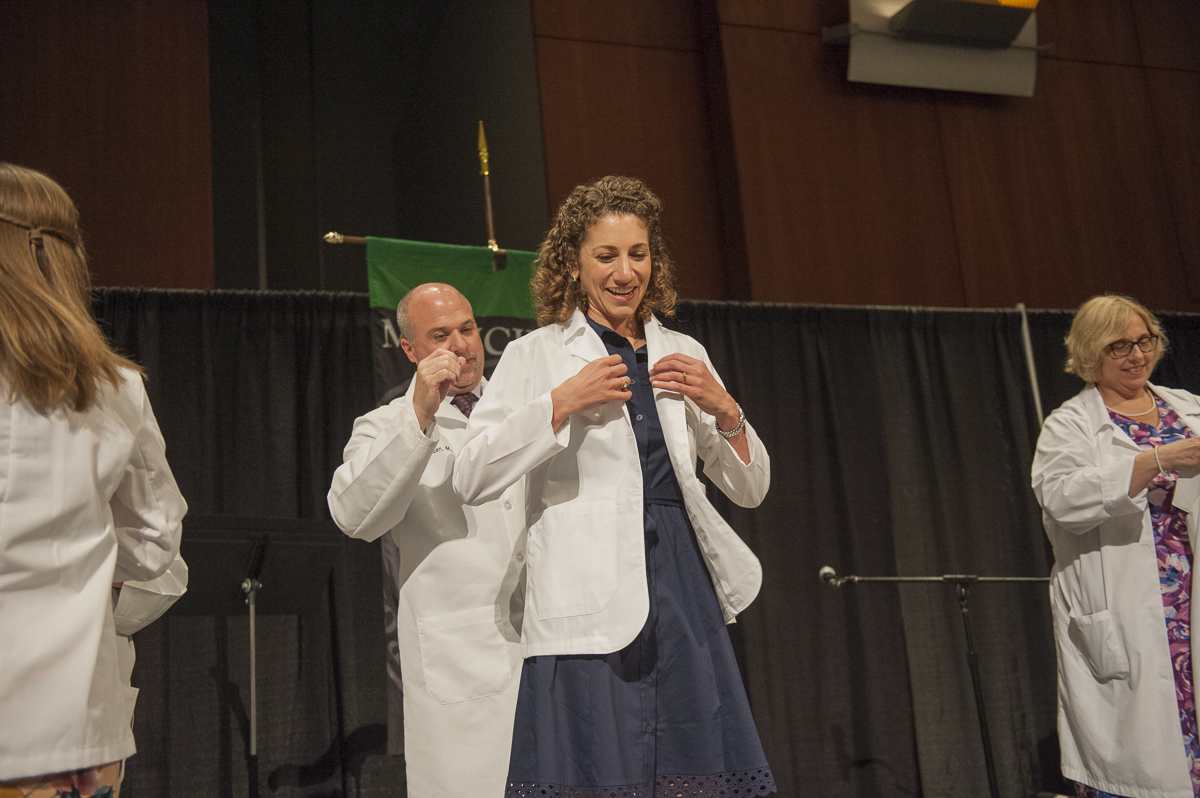 Shira Lanyi donning her white coat at VCU School of Medicine's annual white coat ceremony