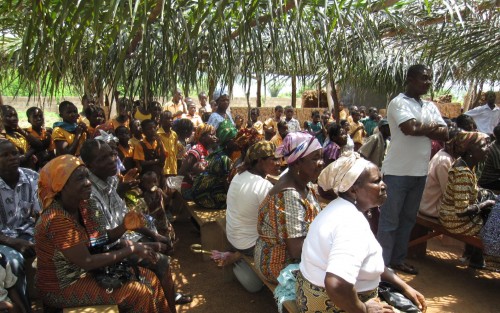 Ghanaian villagers gathered before the clinic