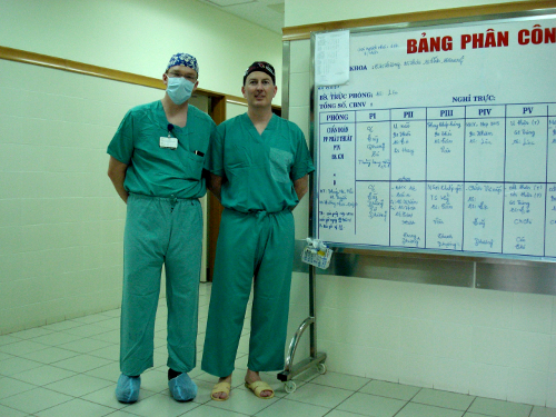 Drs. Lance Hampton (left) and Eric Reid, a urology resident from the University of Oregon outside the operating rooms at Huế University. “Note the short scrub pants and open toed plastic shoes!” Hampton points out.