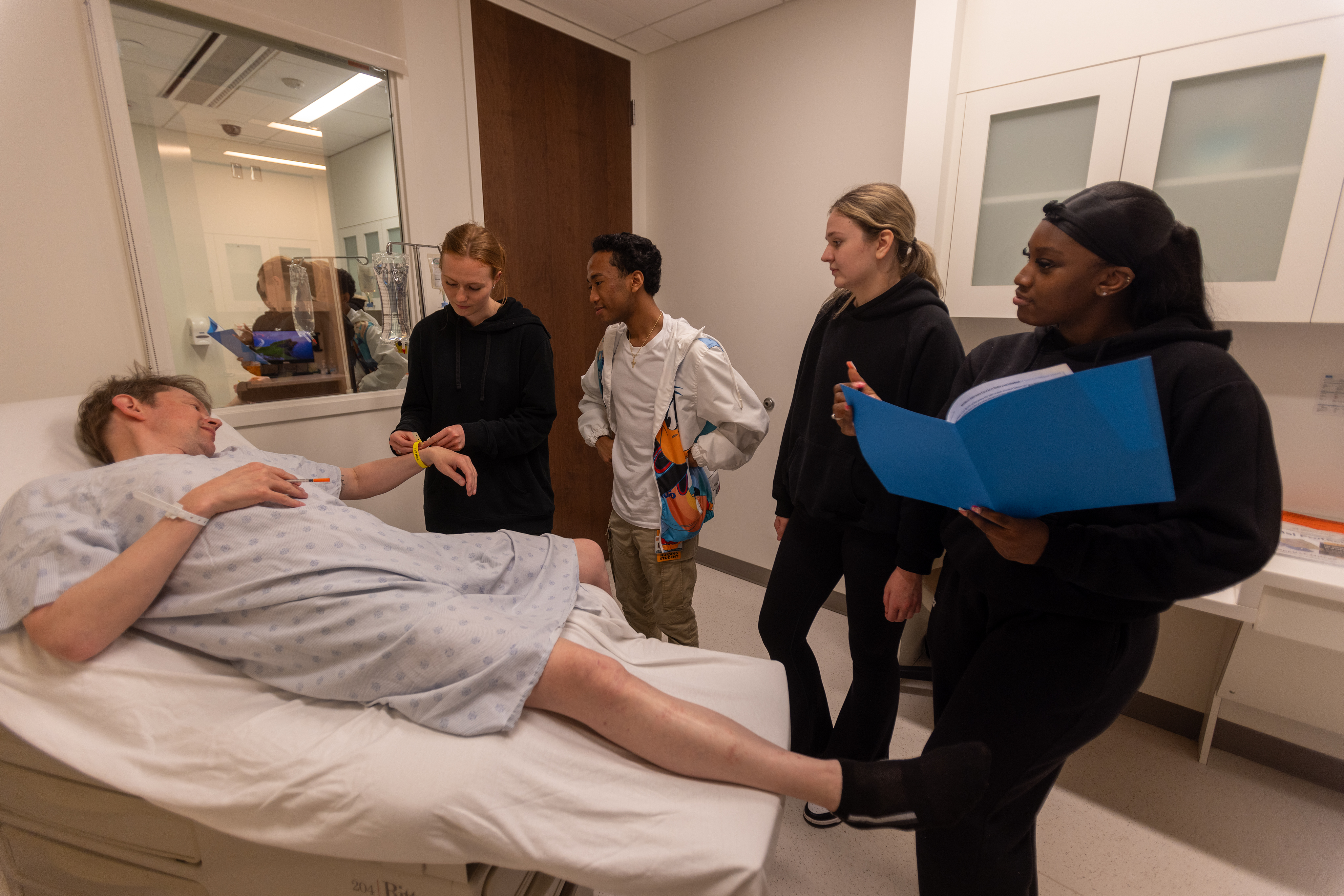 Medical, nursing and pharmacy students work together to escape a simulated hospital room riddled with errors, noting afterward how it took all three professions to succeed. (Photo by Tyler Trumbo, MCV Foundation)